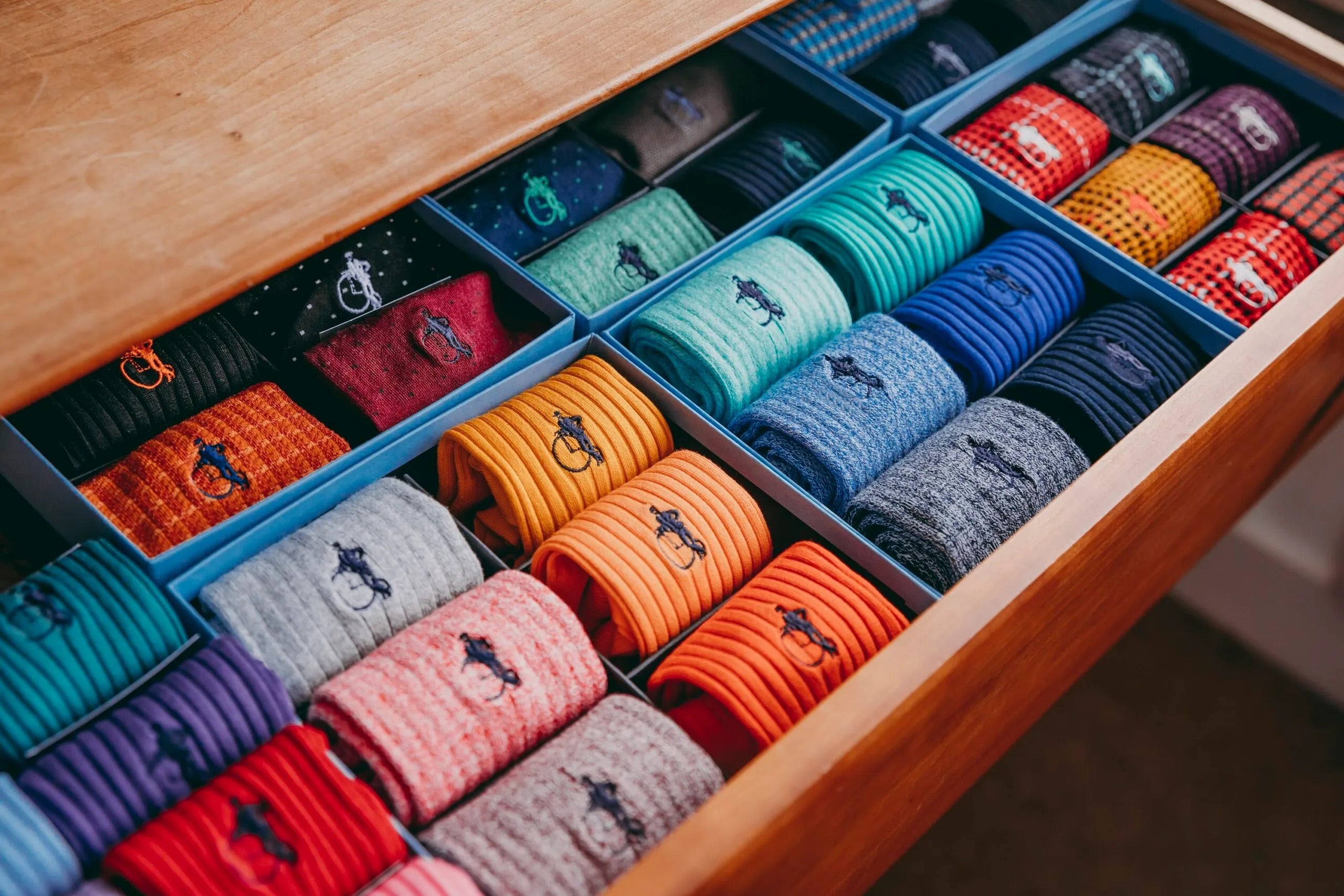 Large drawer full of men's socks that are in presentation boxes