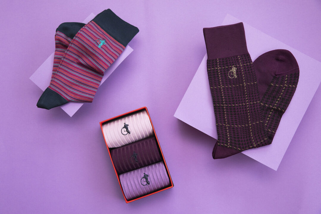 An array of purple socks by London Sock Company on a purple background