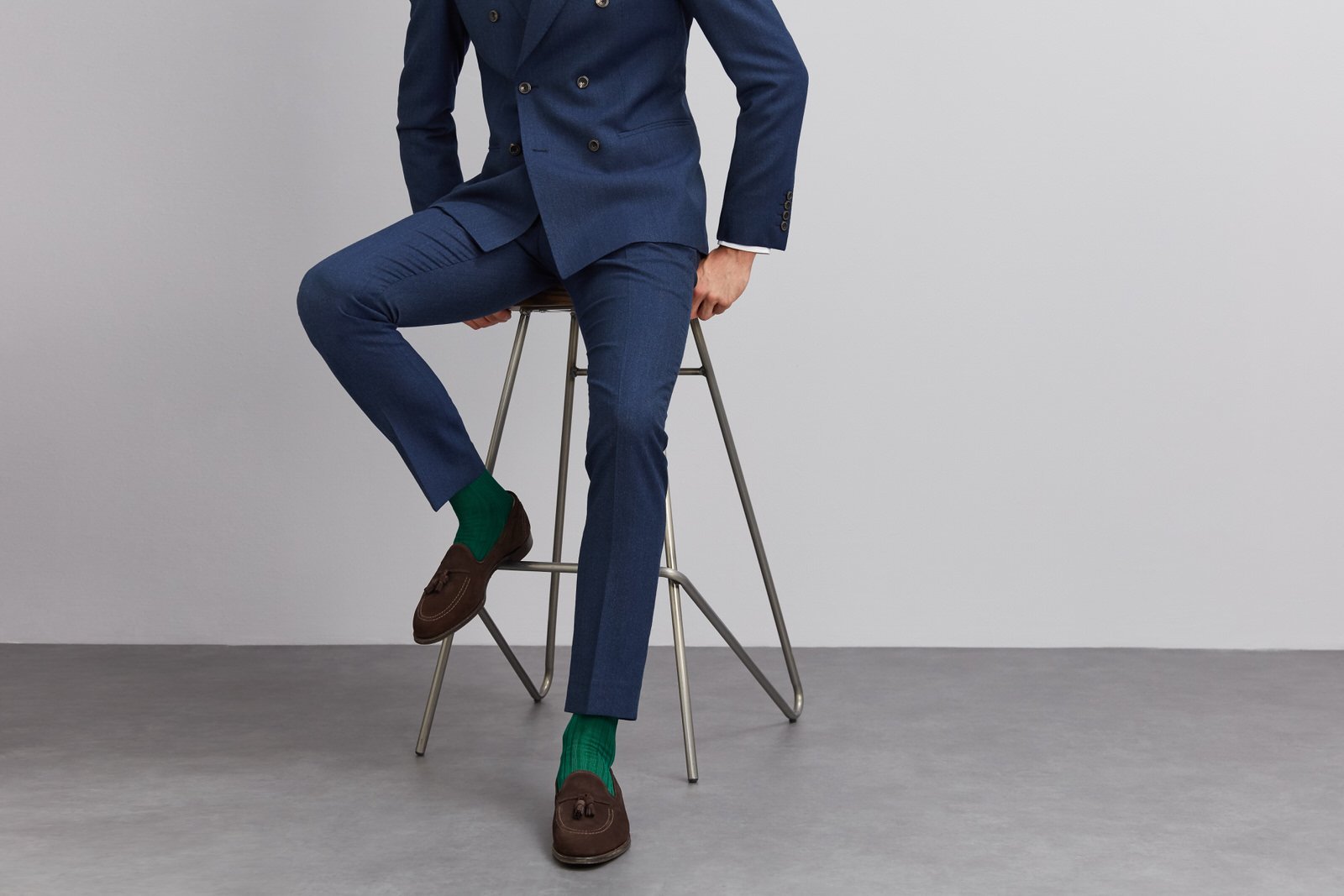 Man in blue suit with bright green socks
