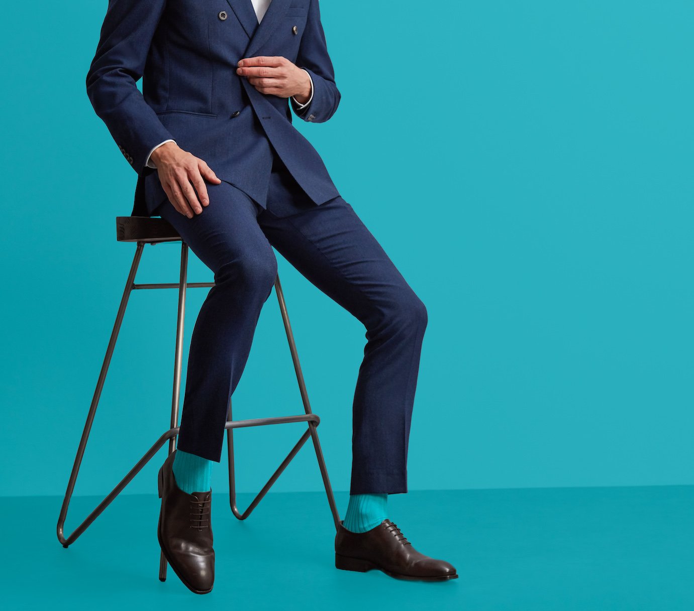 Man in suit and turquoise socks by London Sock Company
