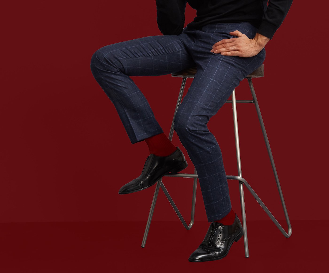 Man on stool in ruby red socks by London Sock Company