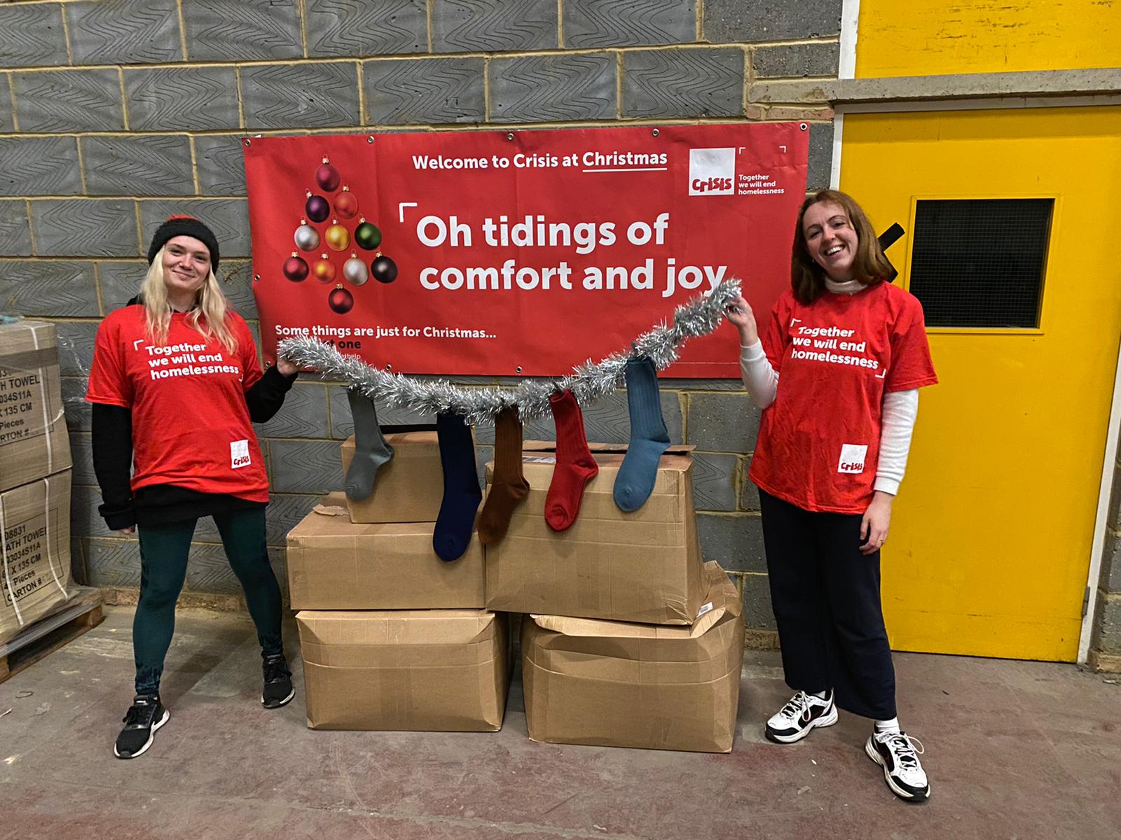 Crisis charity team with socks for the homeless at Christmas