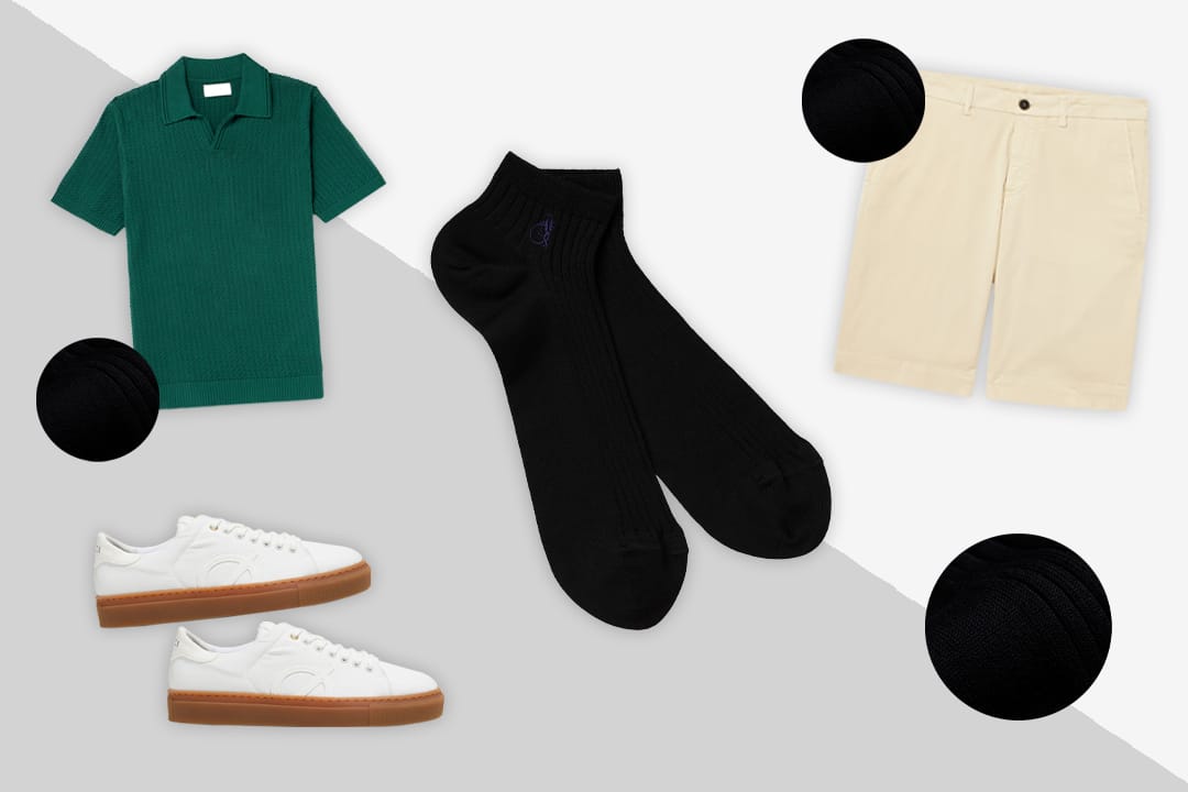 Mens' black ankle sock with green knit polo top, cream cotton shorts and white leather trainers with beige soles.