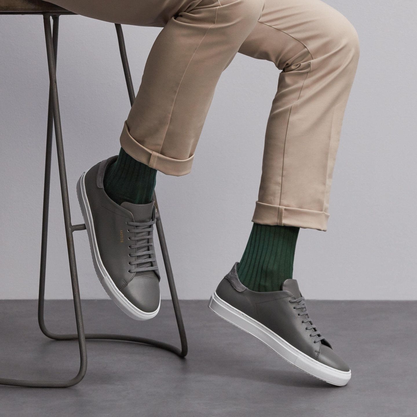 Person wearing green socks with grey shoes