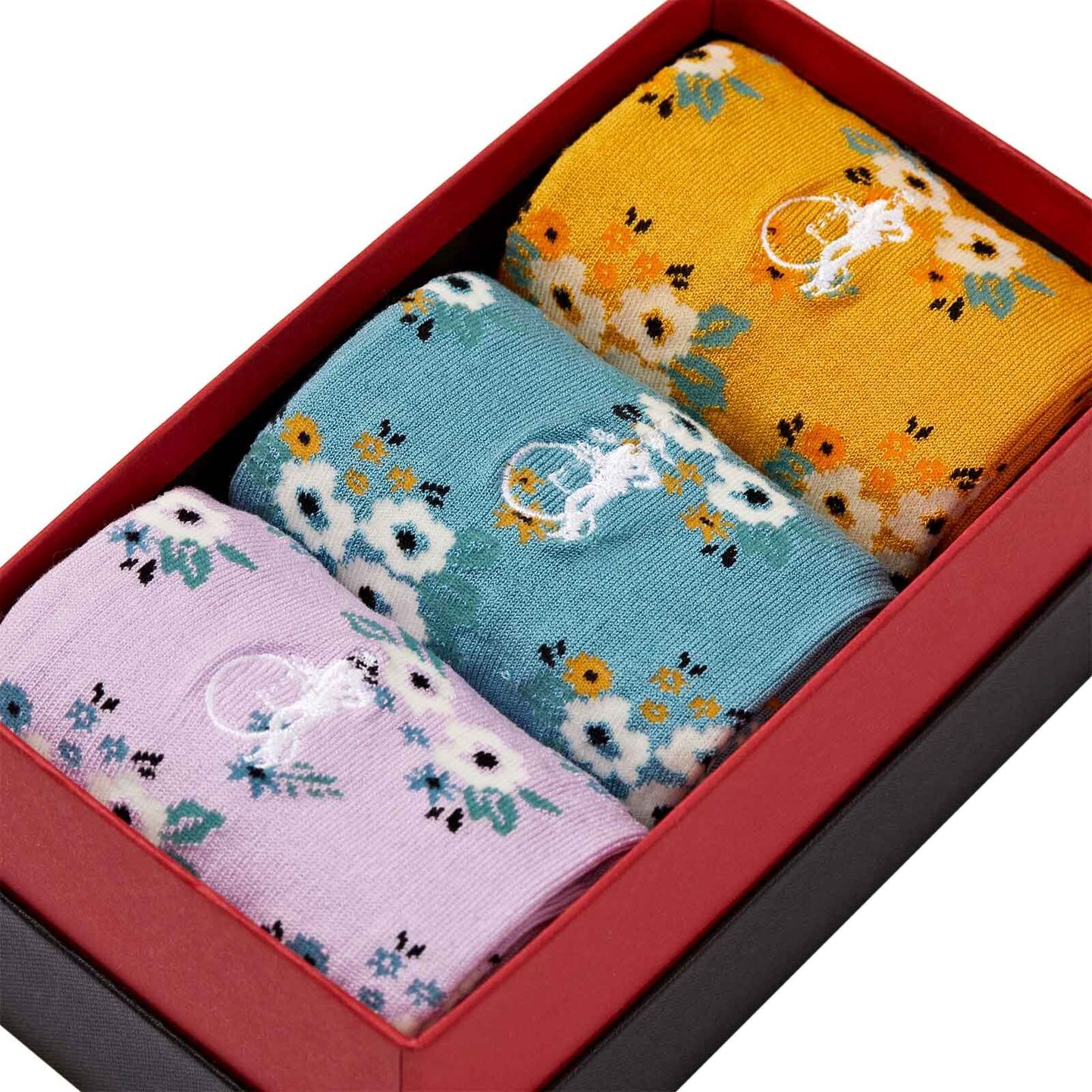 Close up of 3 pairs of floral designed socks in a presentation box