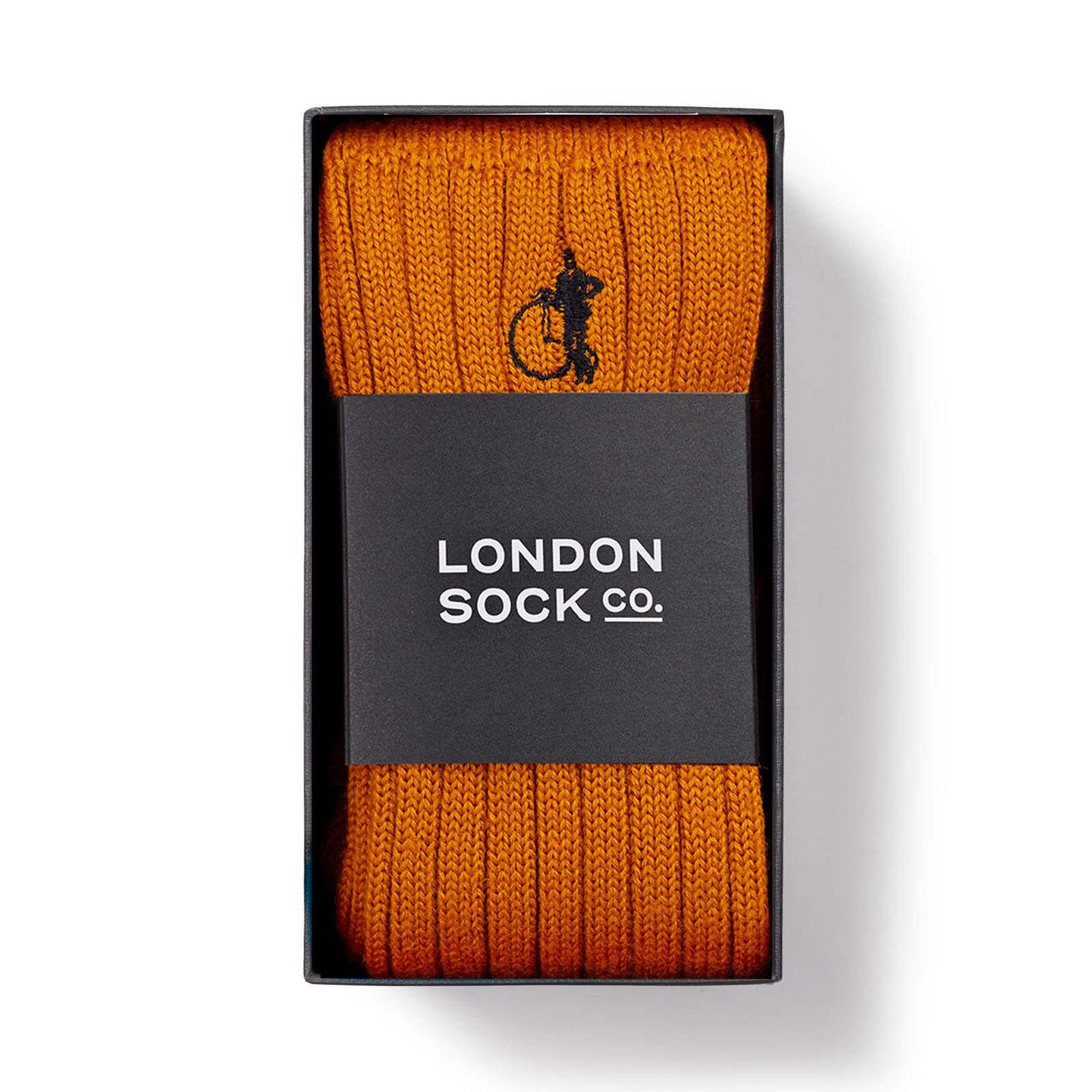 A pair of orange socks in a London Sock Company box