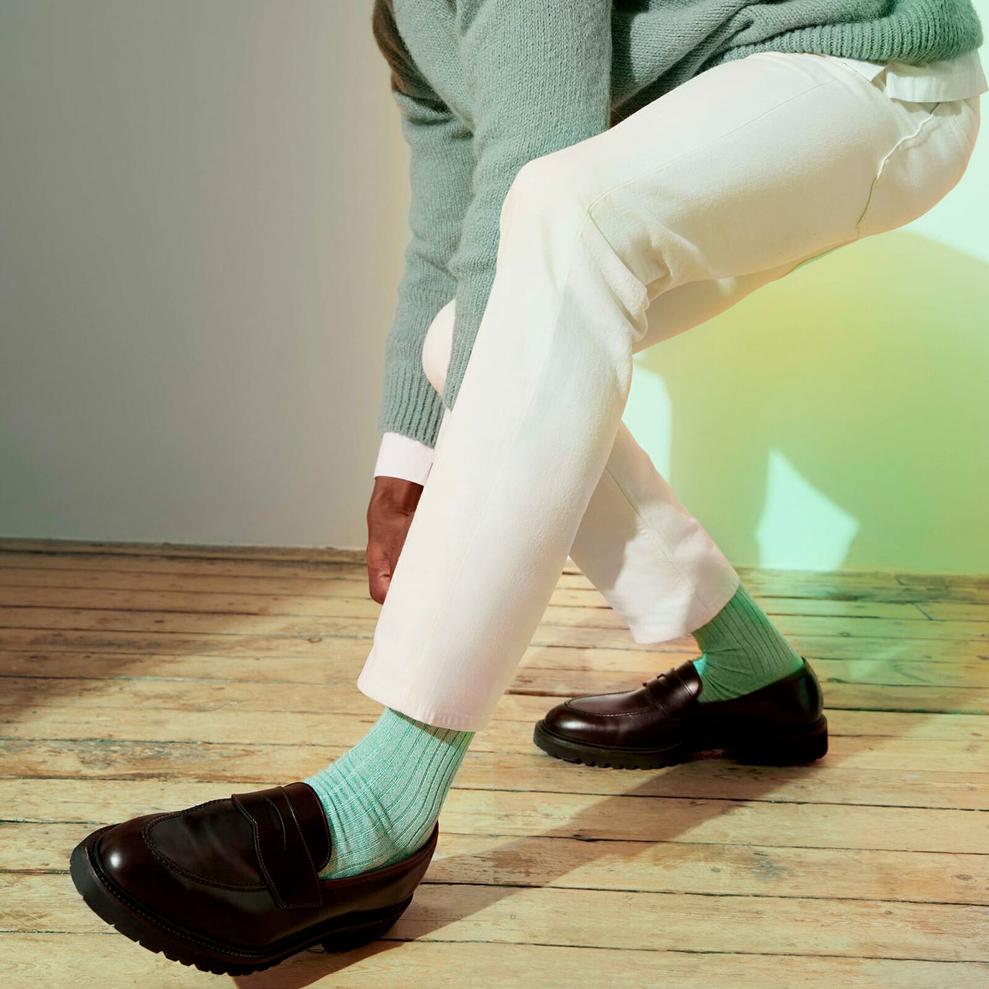 Man crouching down wearing aqua marl socks