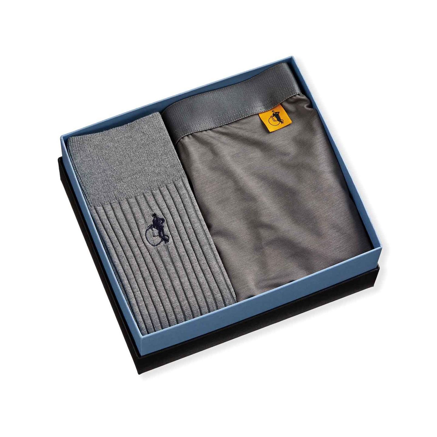 A collection of a pair of socks and boxers in a box