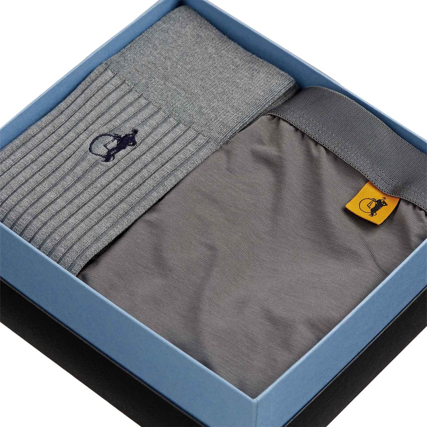 A pair of grey socks packaged together with grey boxers