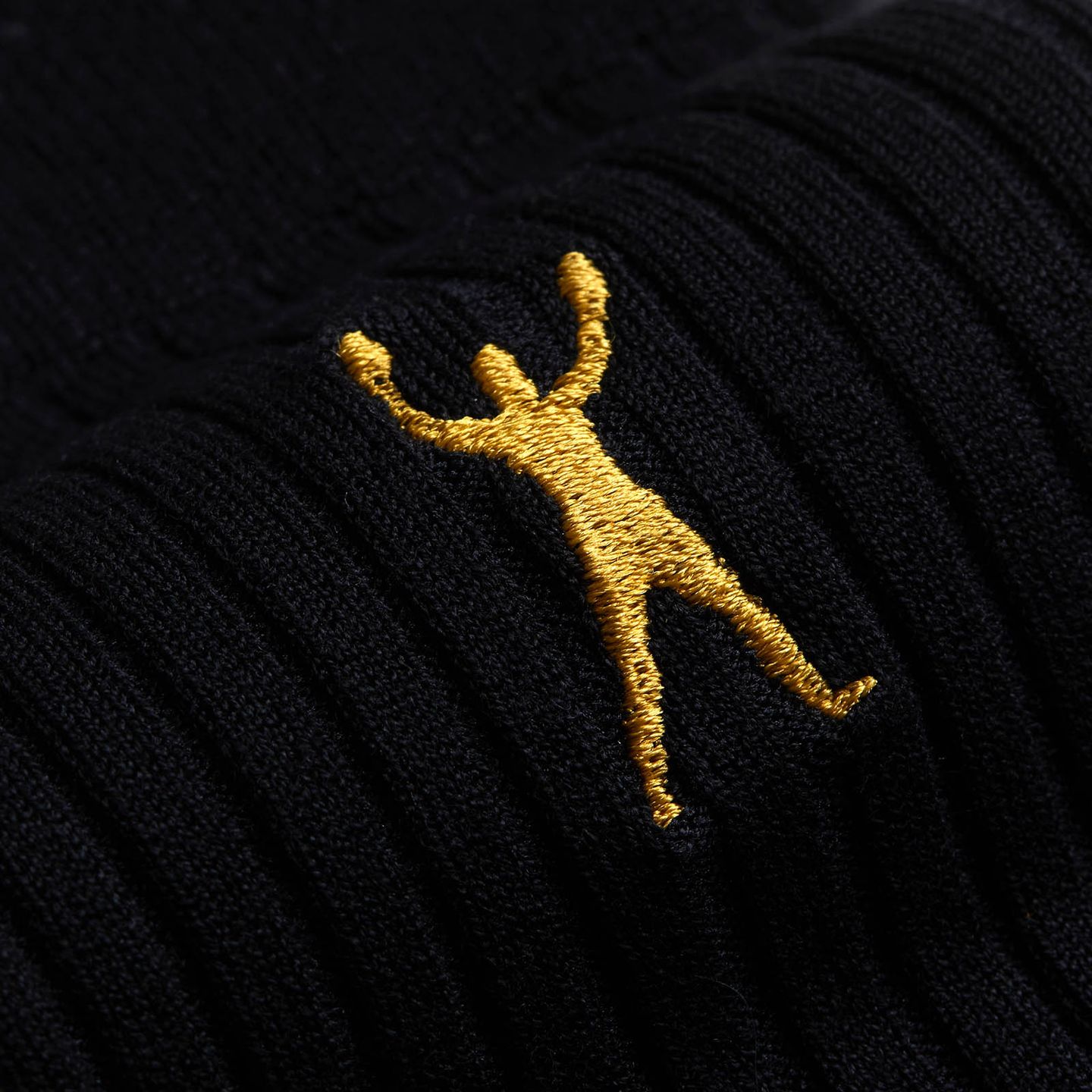 A close up of a yellow character on a black sock