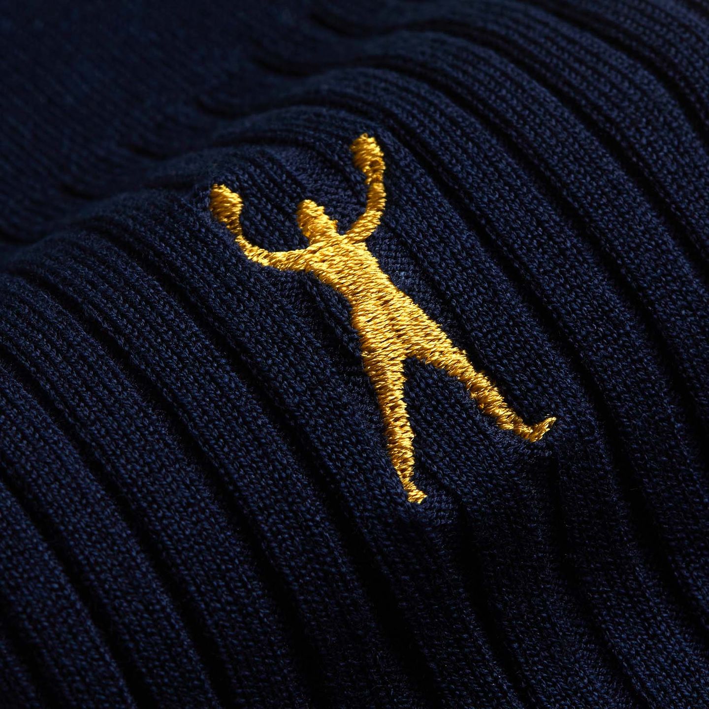 Close up of Muhammad Ali navy socks and the embroidered gold logo
