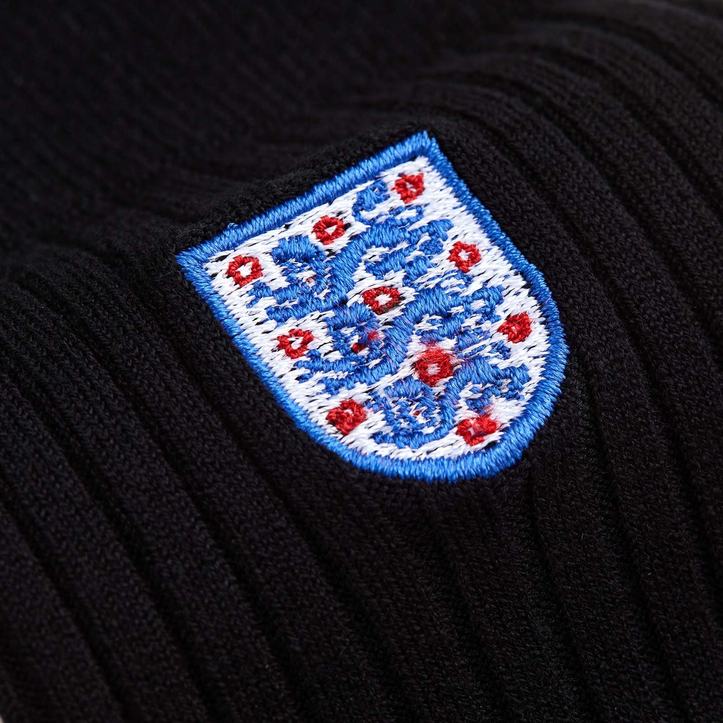 Close up of the England badge on a black pair of socks