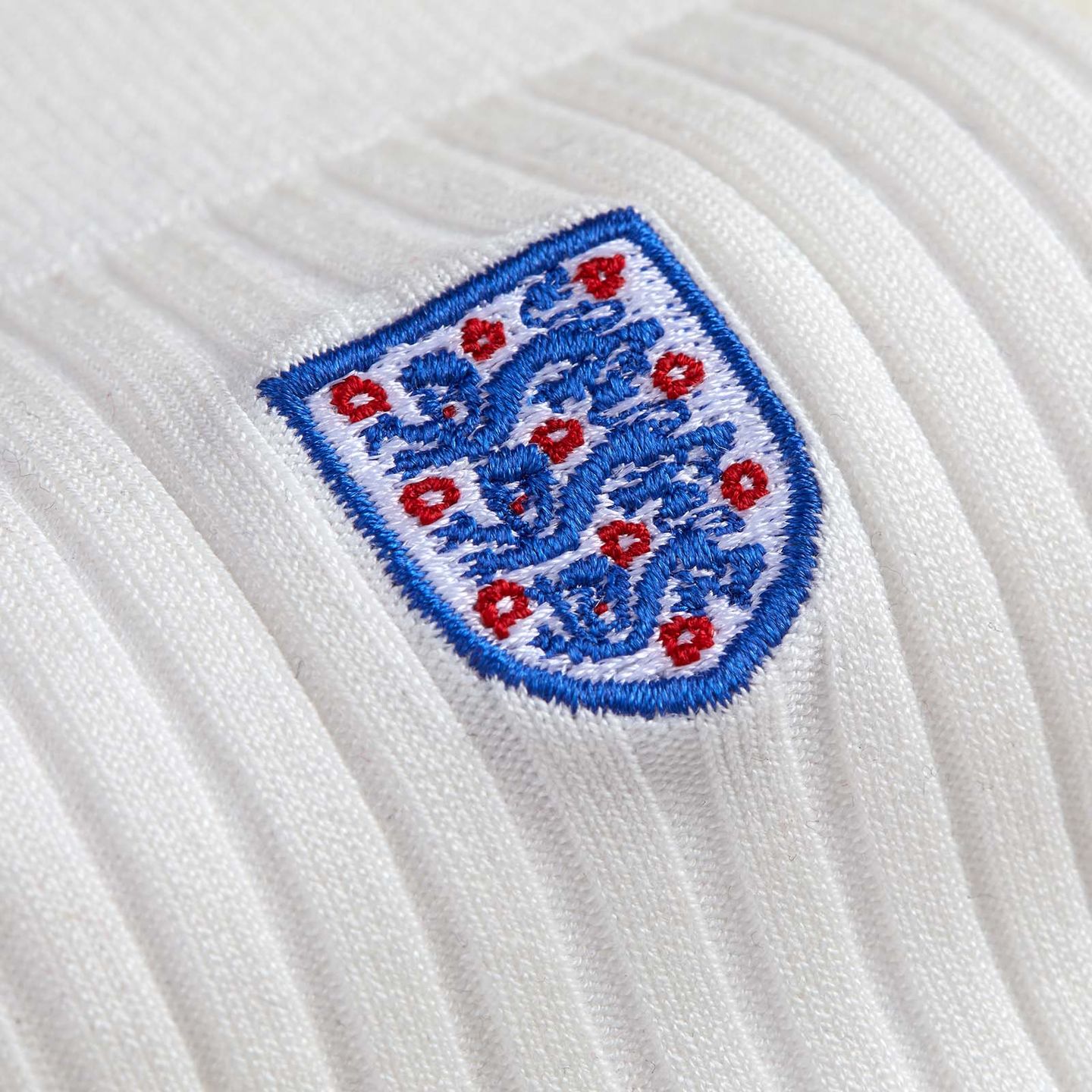 Close up of a white sock with the England 3 lion logo embroidered in