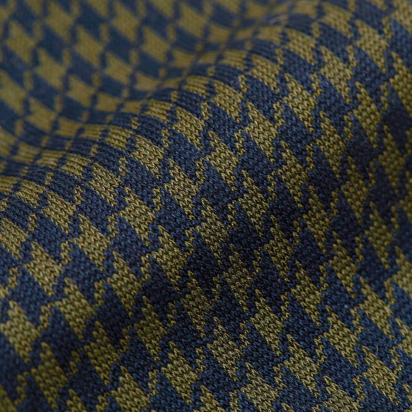 Close up of olive and blue Houndtooth patterned socks