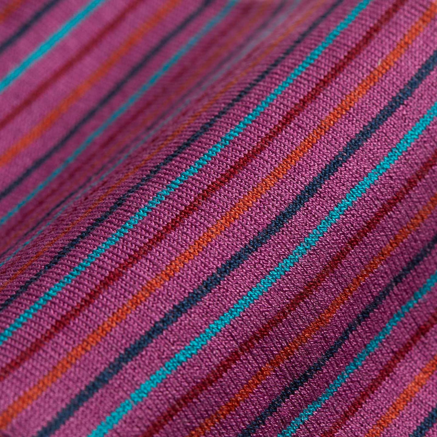 Close up of a Illaria Sunset Stripe sock. Pink sock with thin red, orange and dark blue stripes