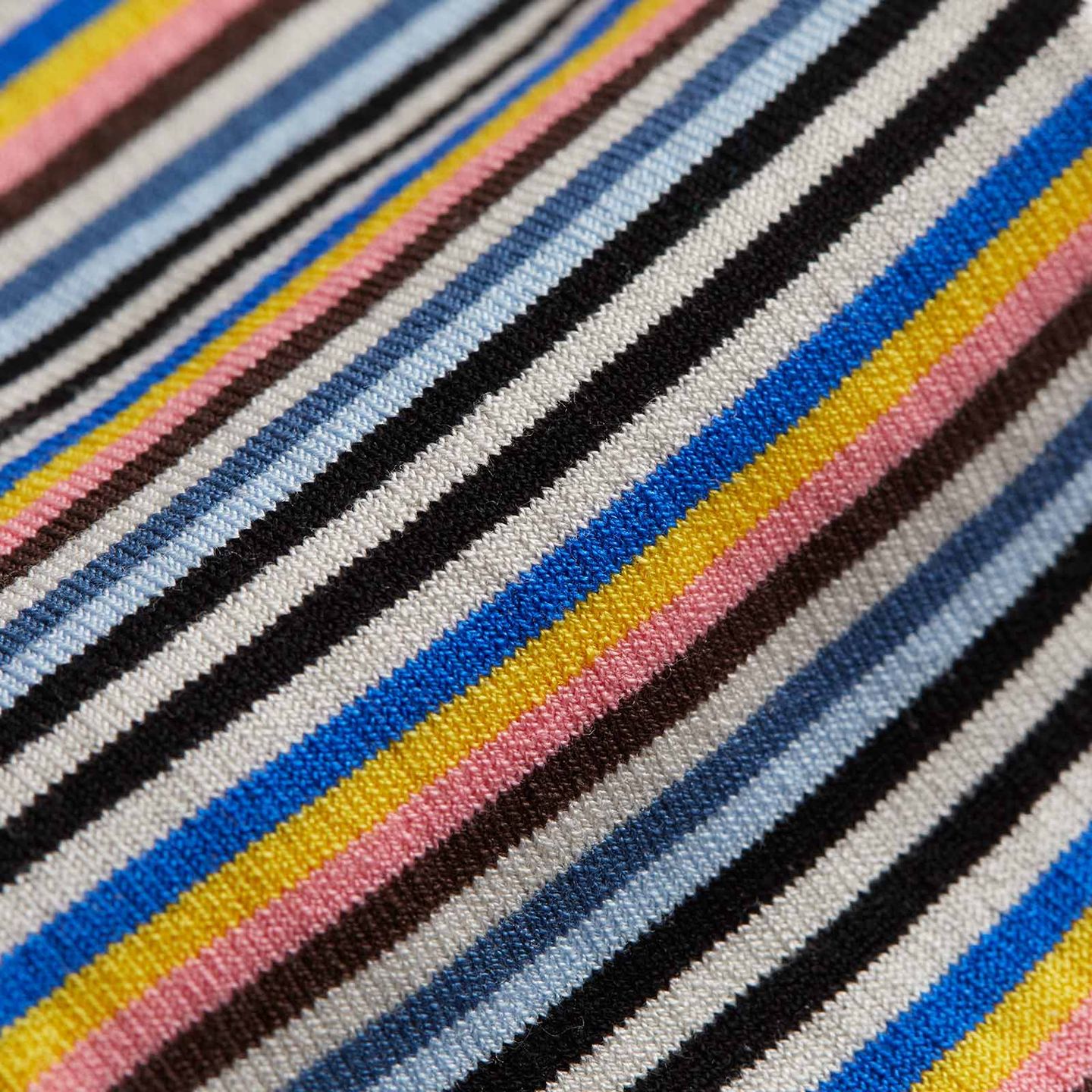 Close up of an Ilaria stripped sock with various blue shades, yellow, pink, brown and white strips