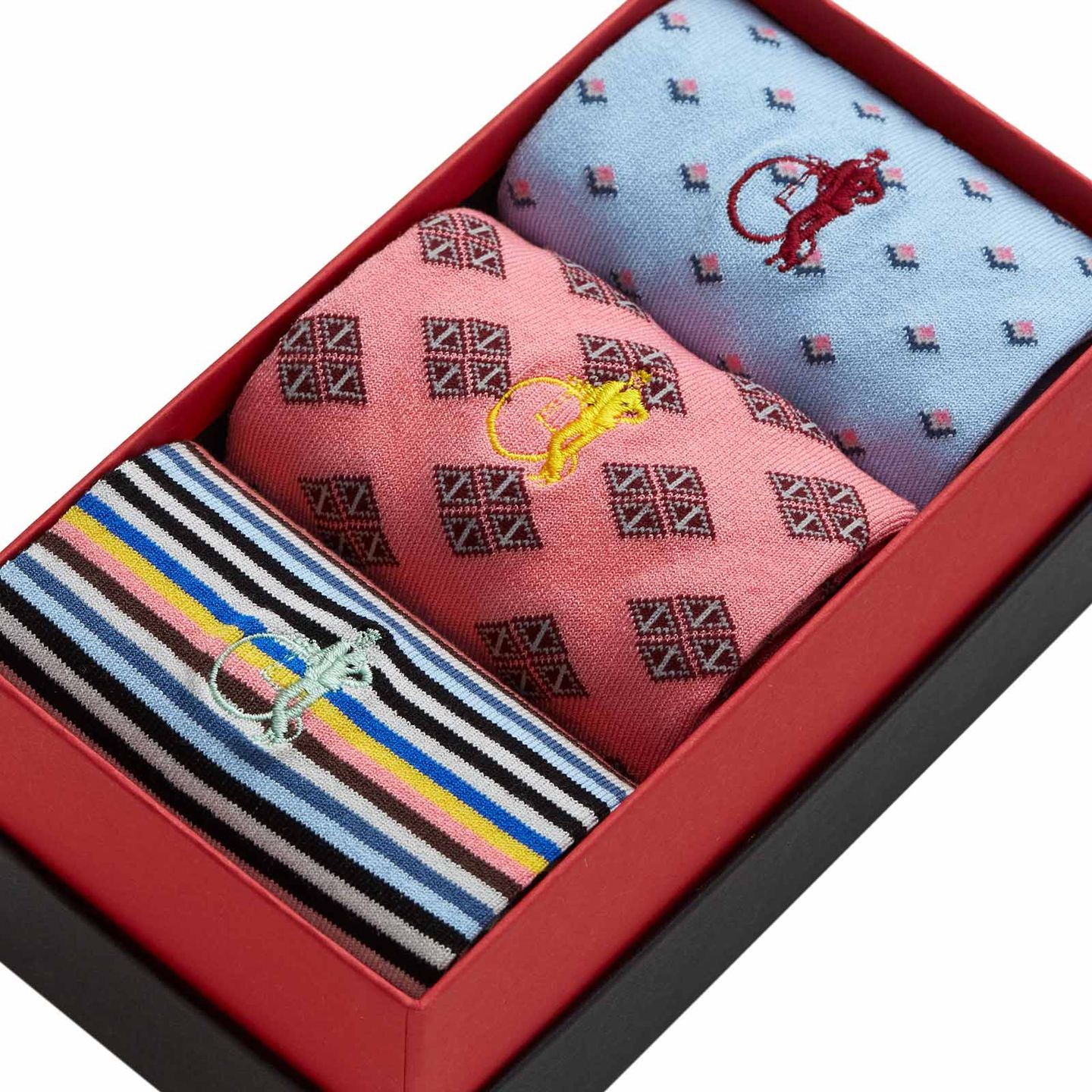 Close up of a presentation box with 3 pairs of diamond and stripped patterned socks