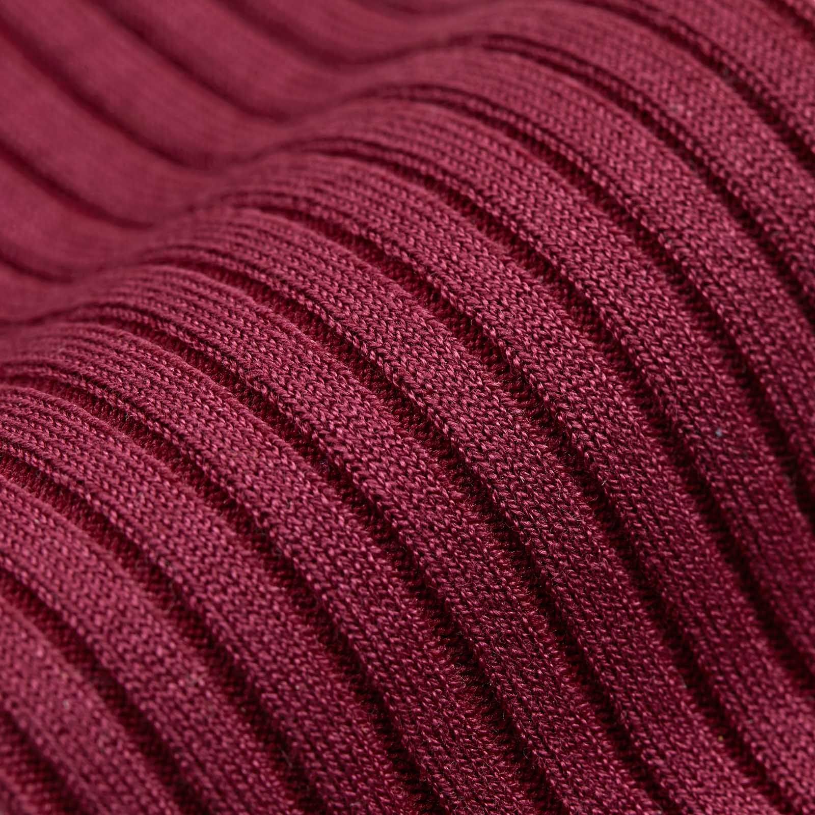 A close up of stripes on a red sock