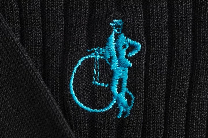 Close up of black socks with the LSC logo in light blue