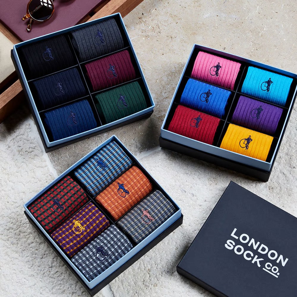 3 presentation boxes of dark, colourful and patterned socks